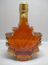 Load image into Gallery viewer, Maple leaf shaped glass bottle filled with Vermont maple syrup made by Tucker Maple Sugarhouse in Westford, VT
