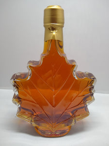 Maple leaf shaped glass bottle filled with Vermont maple syrup made by Tucker Maple Sugarhouse in Westford, VT
